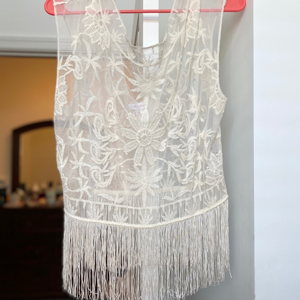 Cream sleeveless shirt with fringe bottom